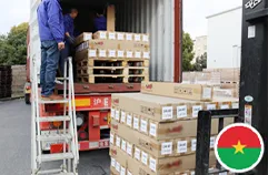 Worker supervising silicone goods on pallets for Burkina Faso