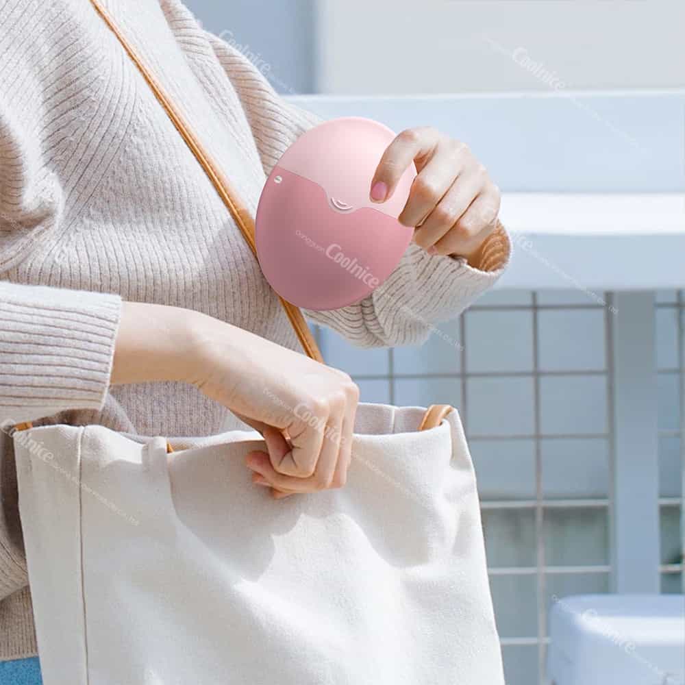 Coolnice silicone sunscreen applicator held in hand, showcasing its portability and ergonomic design