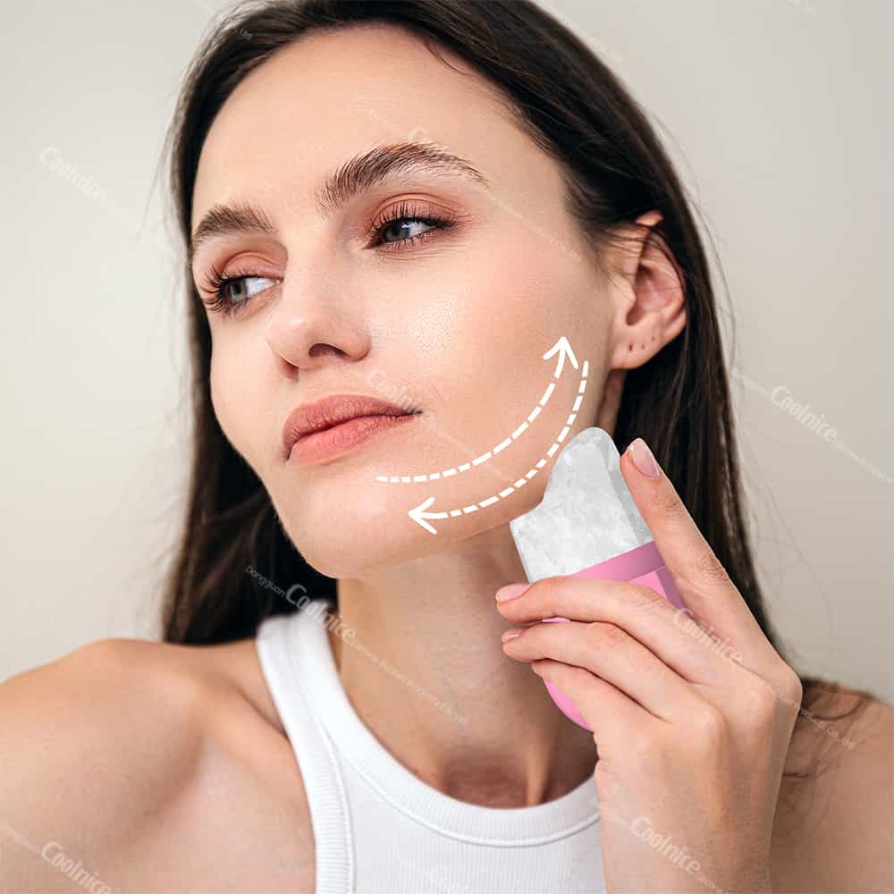 Woman massaging jawline with pink silicone ice roller