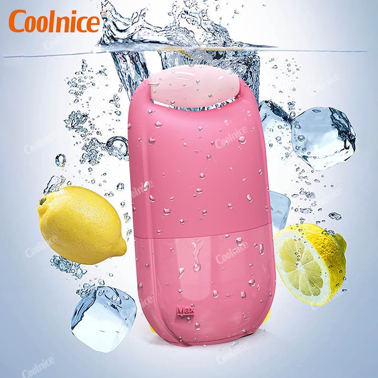 Pink silicone ice facial roller by Coolnice submerged in water with ice cubes and lemon
