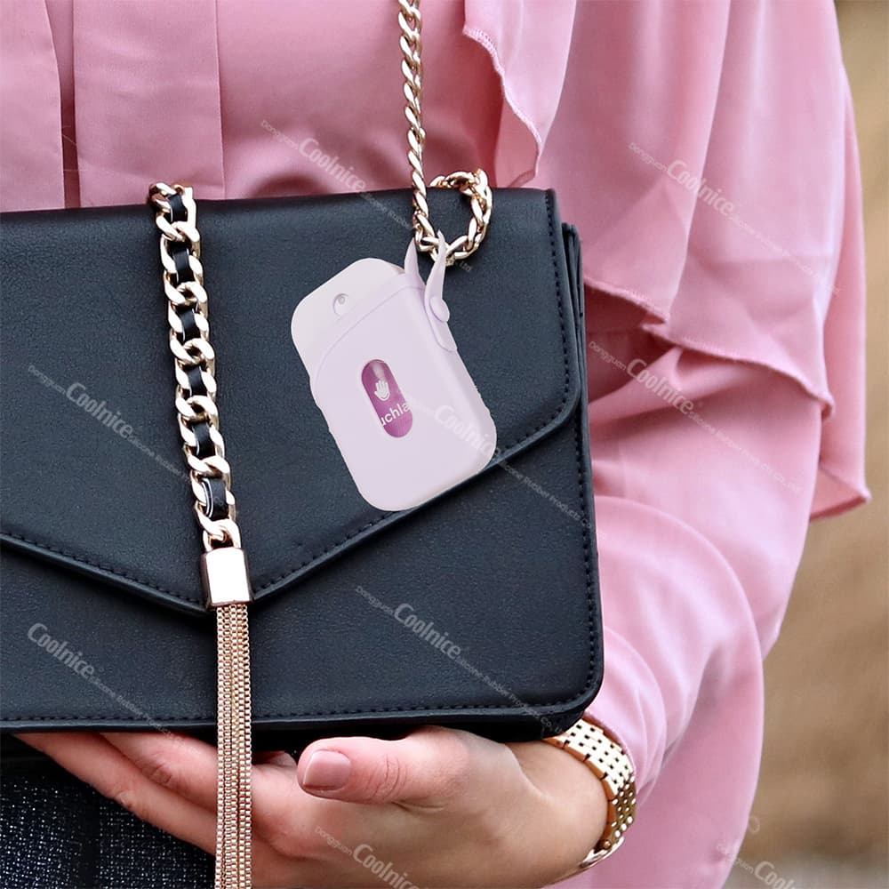 Hand sanitizer spray protector case hanging from a handbag, perfect for on-the-go sanitization.