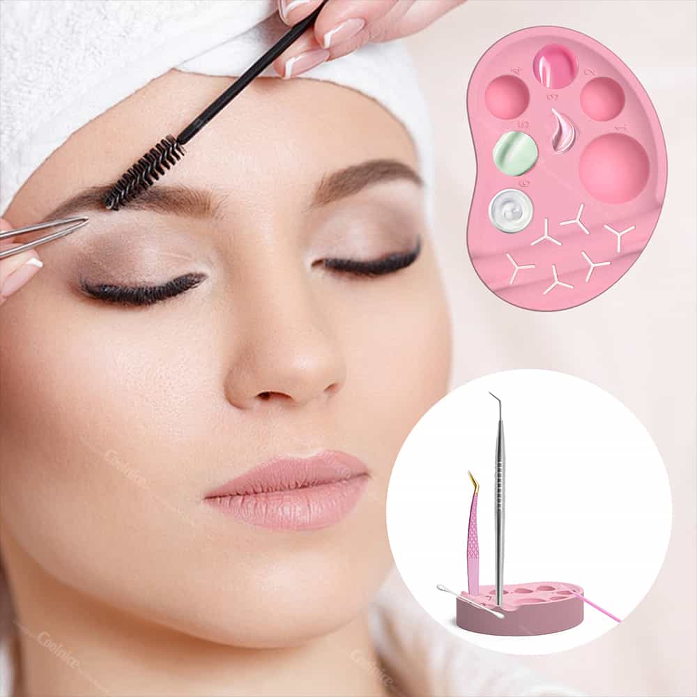 Pink silicone lash and brow tool palette with multiple wells and slots for tweezers, glue, and lotions.