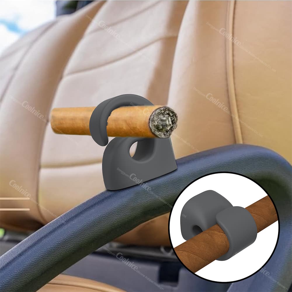 Magnetic silicone cigar holder attached to a car seat armrest, holding a cigar securely, with close-up view of the holder around the cigar.