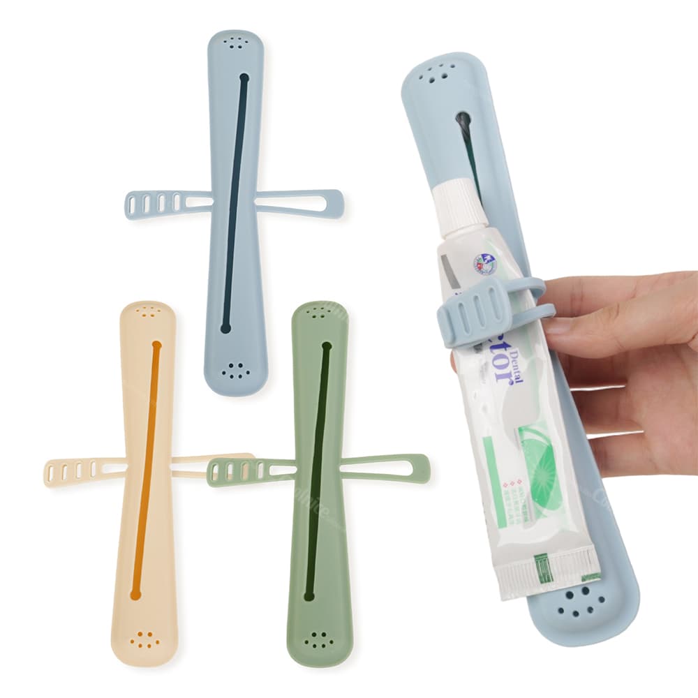 Colorful silicone toothbrush holders in orange, green, and blue, with elastic tape to secure toothpaste tubes, shown with a toothpaste tube in the blue holder.