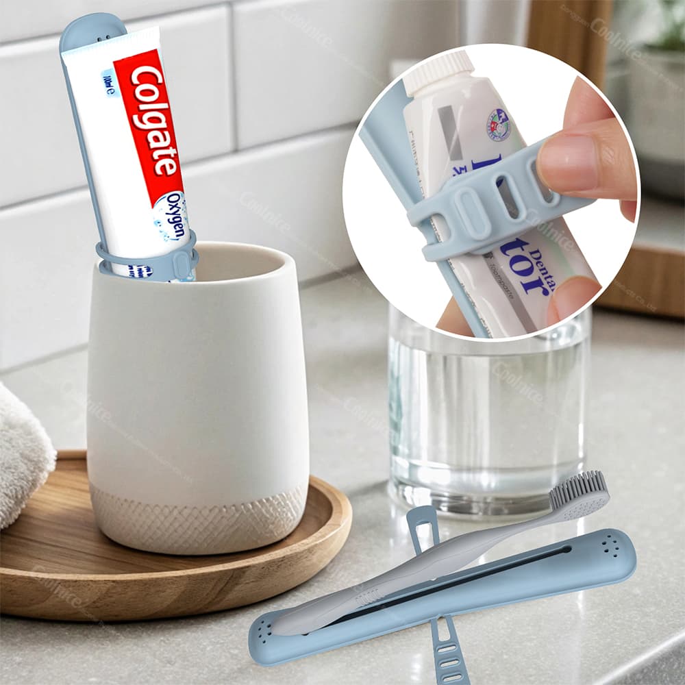 Blue silicone toothbrush holder with elastic tape holding a toothpaste tube, placed in a bathroom setting alongside a toothbrush holder.