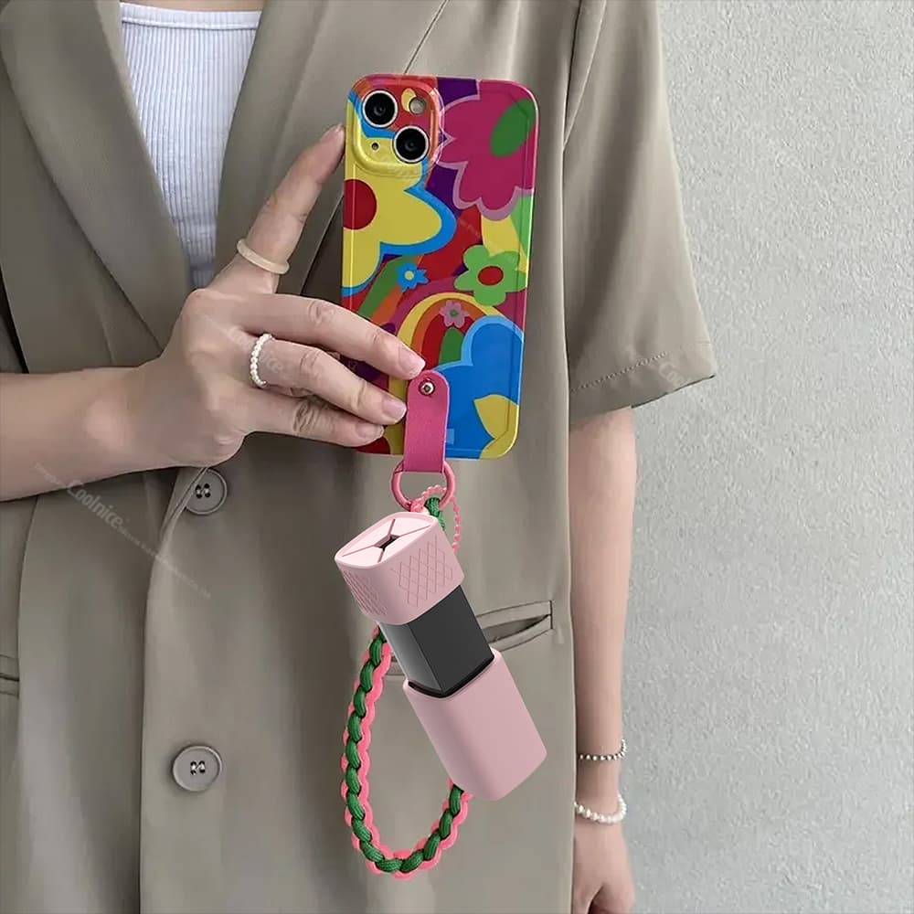 Silicone lipstick holder attached to phone case strap