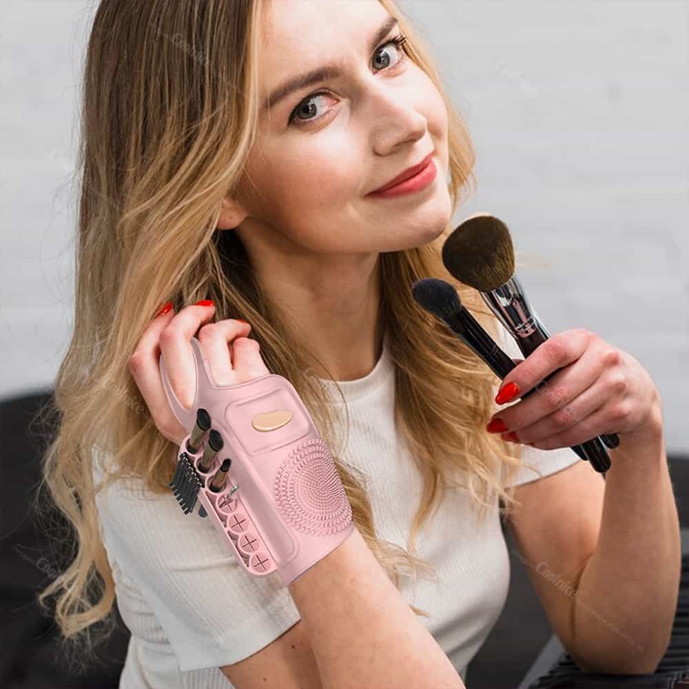 Pink silicone wrist brush cleaner pad in close-up use.