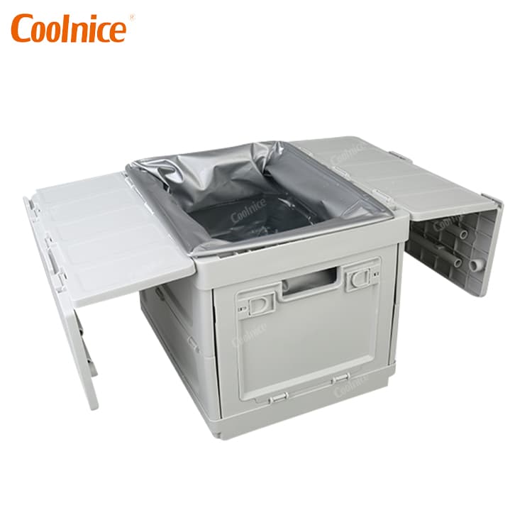 Foldable camping box with waterproof liner and side tables extended.