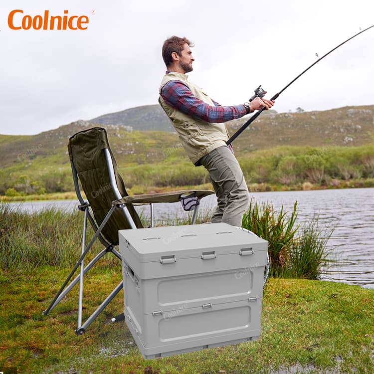 Portable camping box for fishing trips, shown beside an angler by the lakeside.