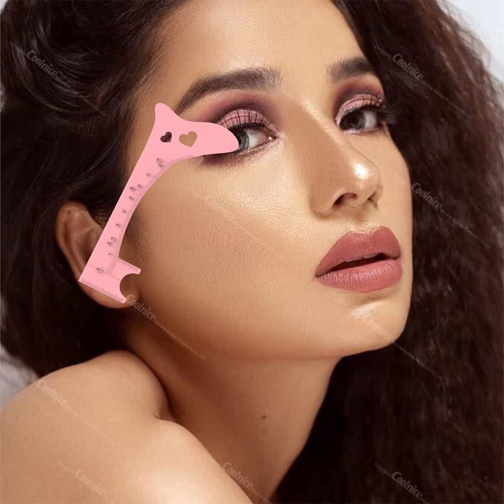 Pink eyebrow shaping ruler used for makeup application