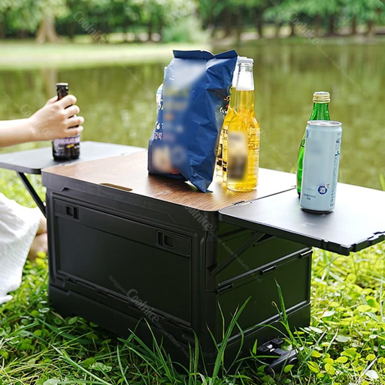 Collapsible camping storage box with fold-out side table for outdoor dining.