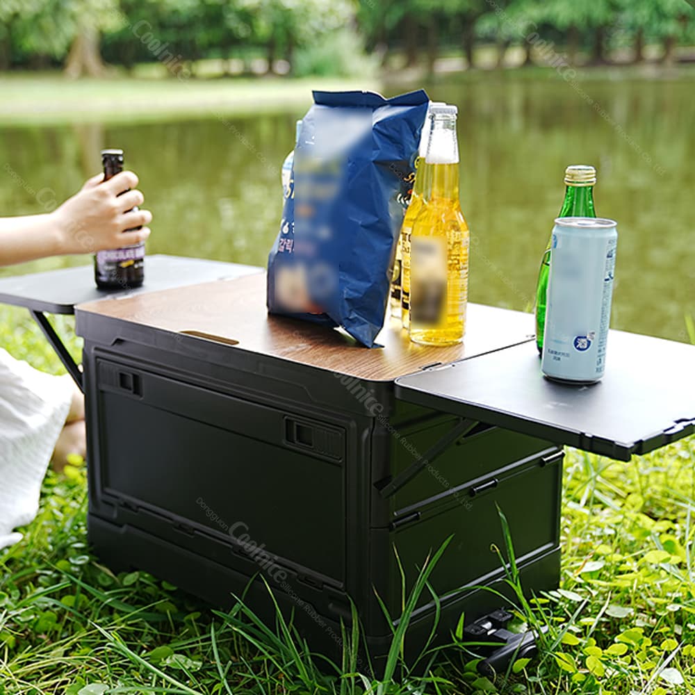 Collapsible camping storage box with fold-out side table for outdoor dining.
