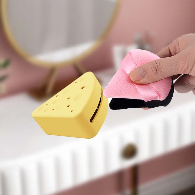 Placing makeup puff into silicone storage case