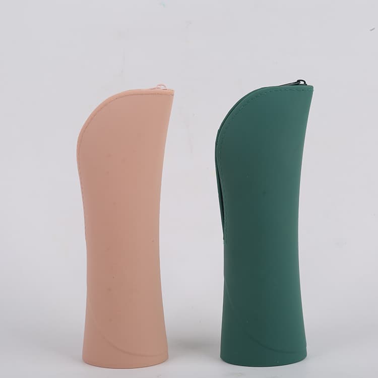 Pink and green silicone makeup brush bags standing upright