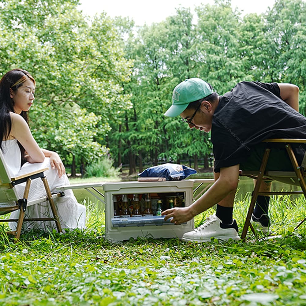 Collapsible camping storage box with front opening door used for outdoor picnic and drink storage.