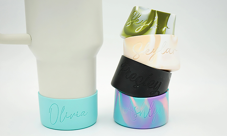 Custom silicone tumbler sleeves with debossed names, featuring no color in the embossed design.