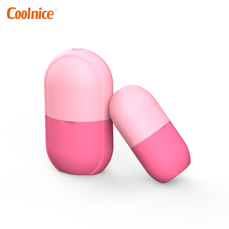 Pink silicone capsule ice cube rollers set on white background