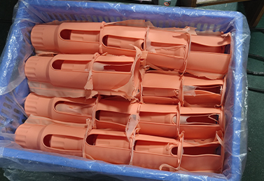 Bulk packaged silicone cup sleeves in orange, ready for shipping.