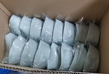 Bulk packaged silicone tumbler snack bowls in light green, sealed and ready for shipment.