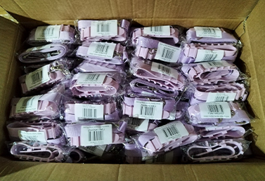 Bulk packaged silicone tumbler strap accessories in purple, sealed and ready for shipment.