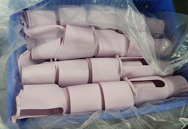 Bulk packaged silicone tumbler sleeves in purple, sealed for shipment.