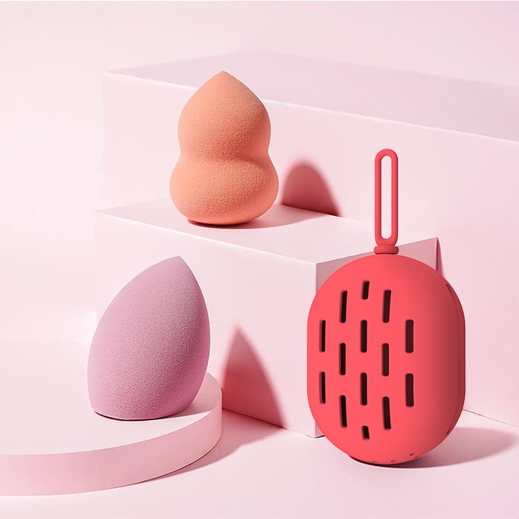 Red silicone beauty sponge holder displayed with cosmetic sponges
