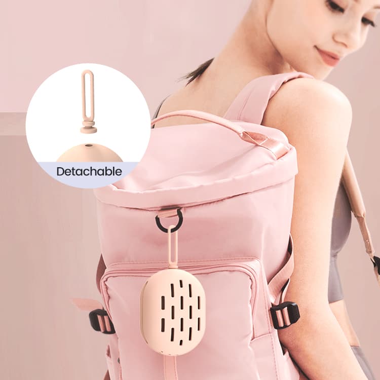 Silicone makeup sponge case attached to a backpack with detachable loop